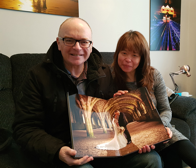 happy couple receive hand made wedding album from Italy